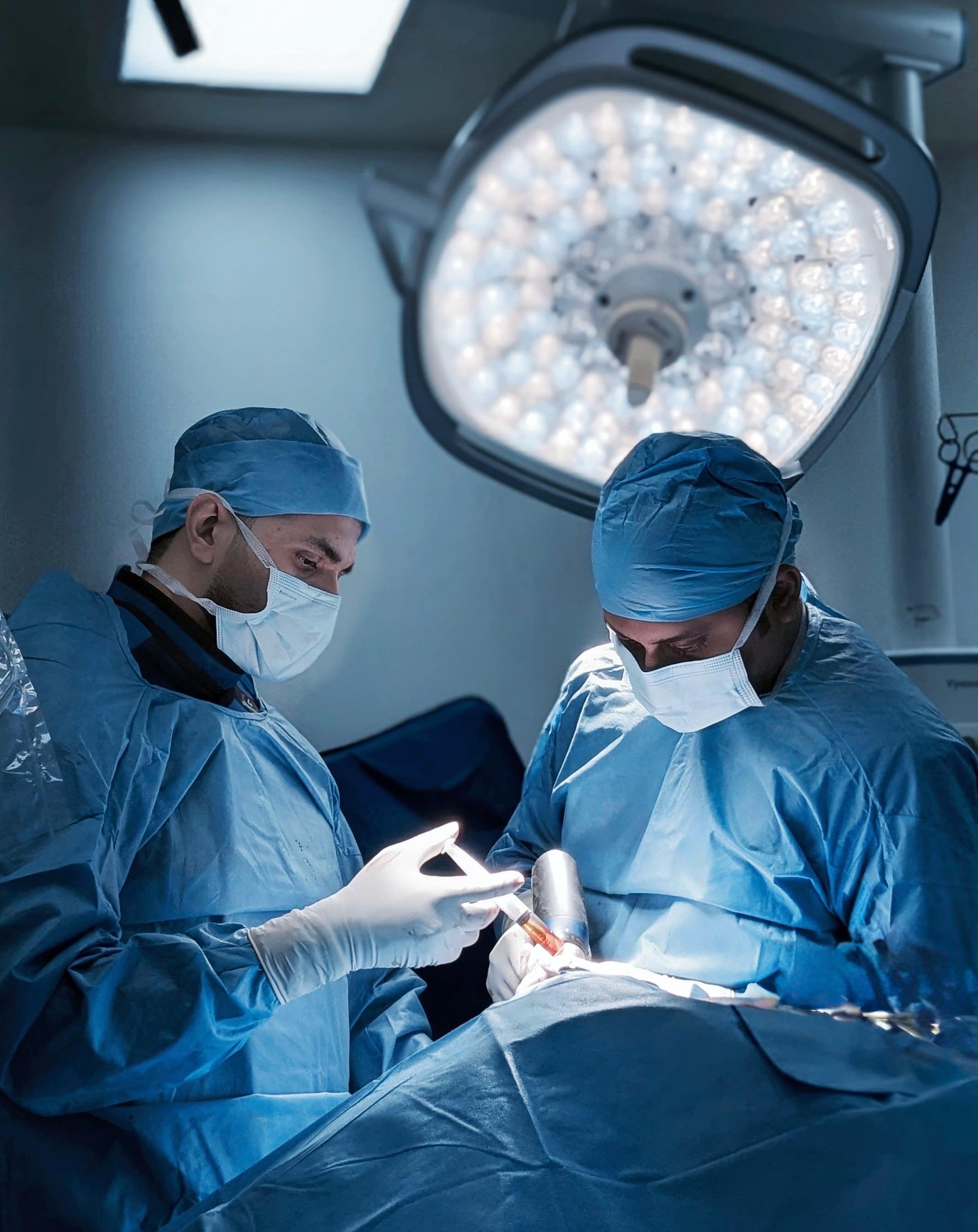 a man is cutting a piece of plastic with a pair of scissors