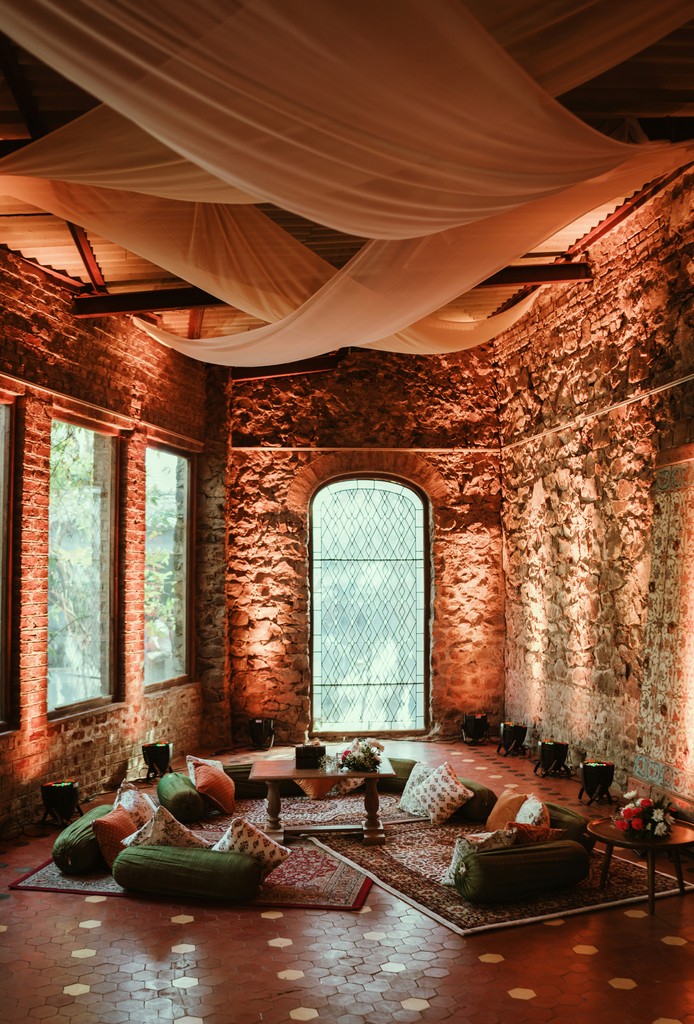 a room with a lot of windows and a rug on the floor