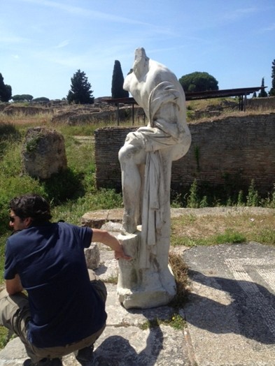 man holding ancient statue