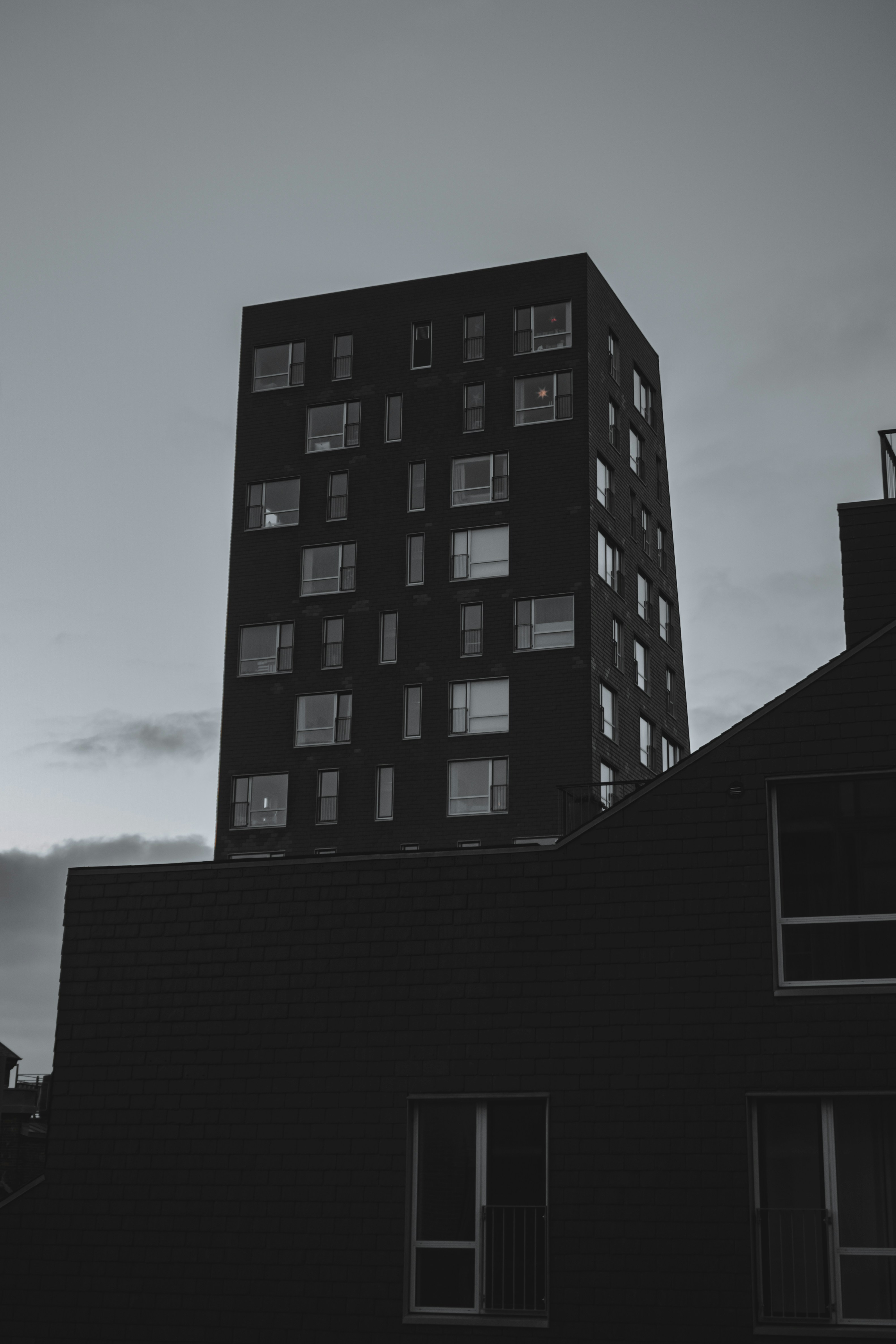 Modern dark building against a cloudy sky