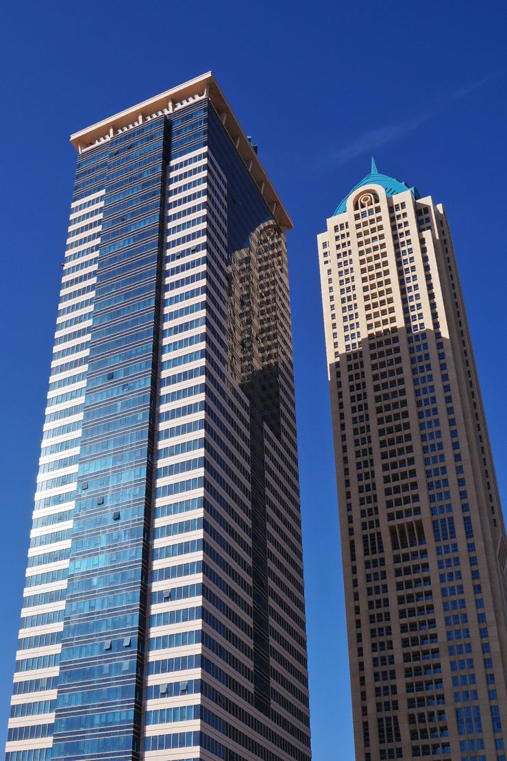 Close-up of Churchill Tower's modern glass architecture, showcasing prime commercial and residential real estate.
