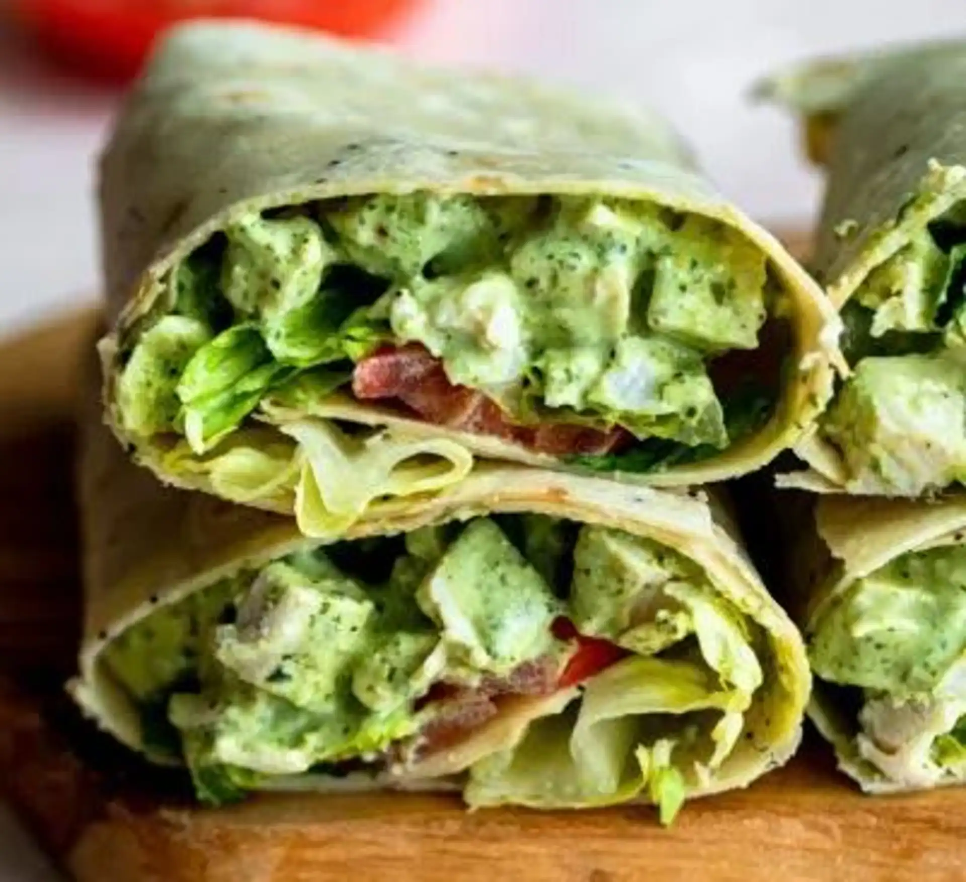 Salad-Ology wrap cut in half showing fresh fillings