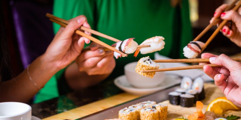 Customers eating sushi at a restaurant