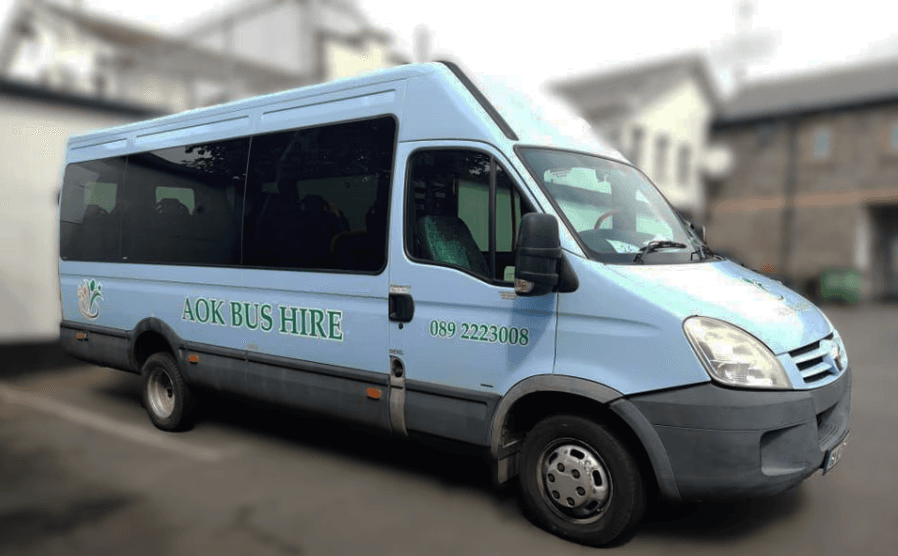 Image of a Mini Bus with AOK Bus Hire on the side of it.