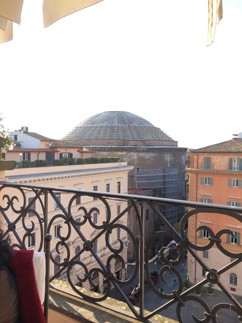 A photo of a building dome taken from the balcony of another building.