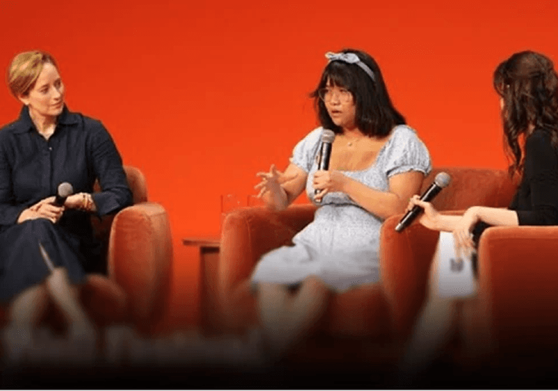Three woman having a discussion with one another