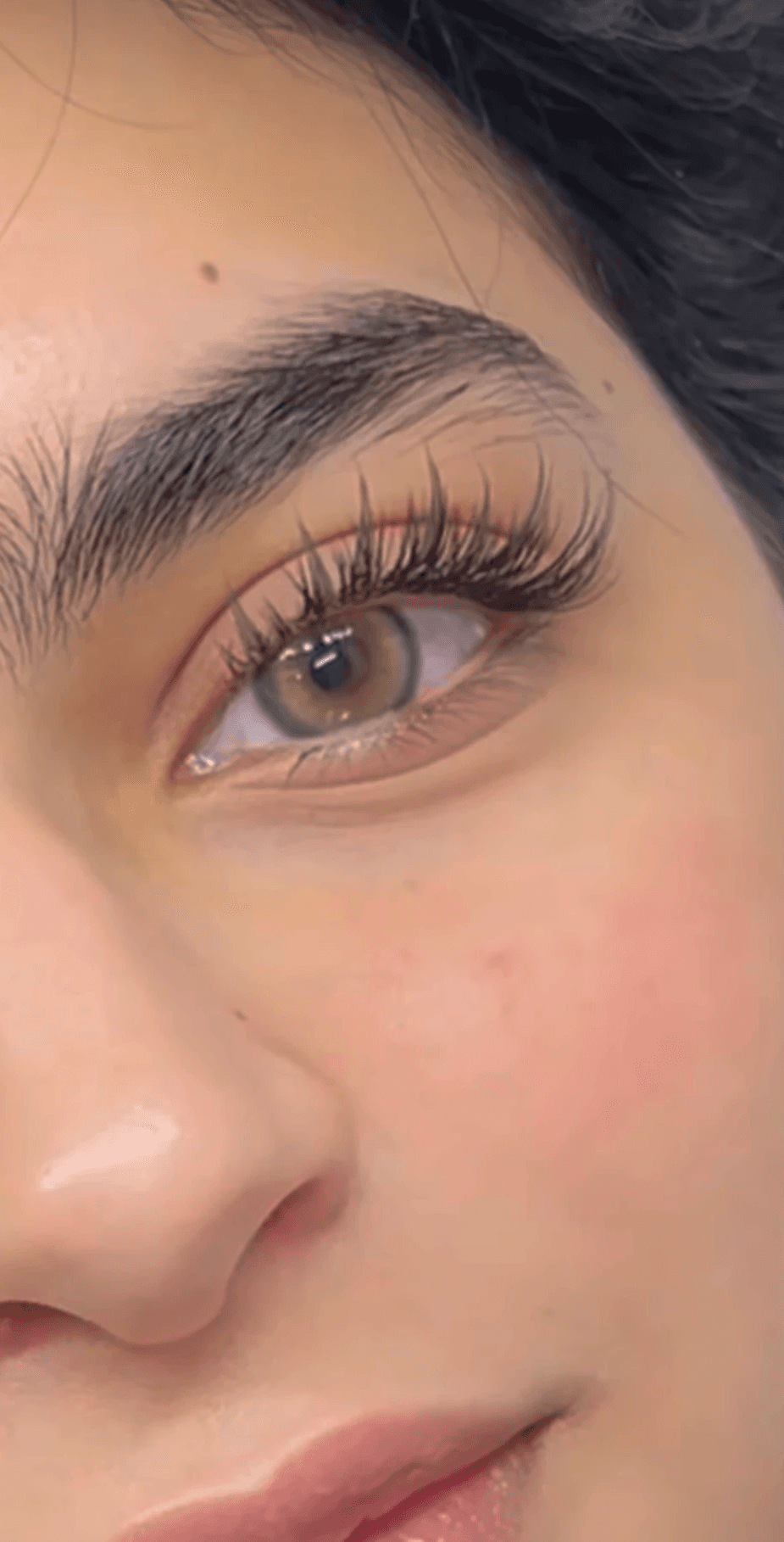 Golden christmas ornaments on a decorated tree.