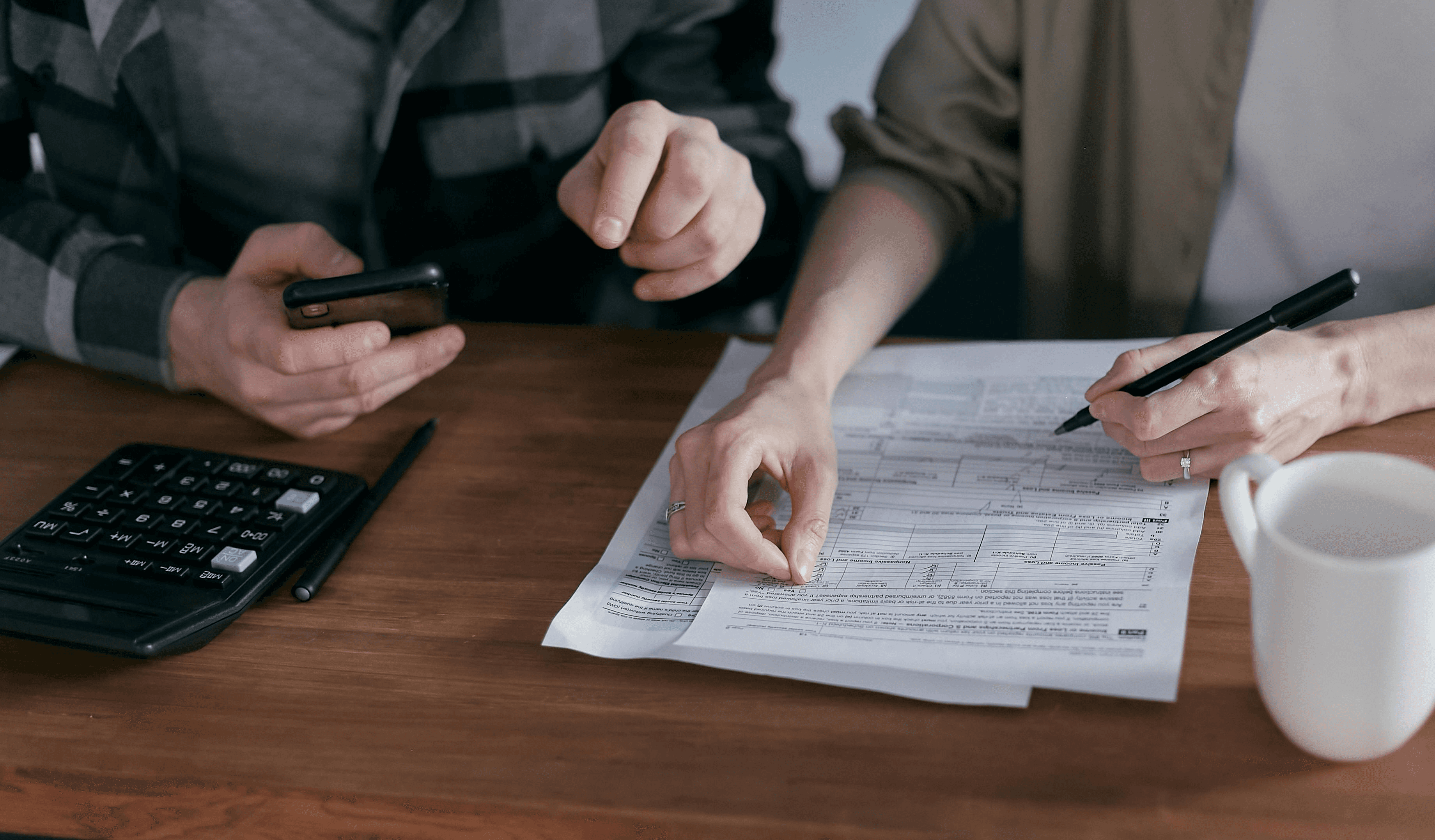 People looking at property finance papers