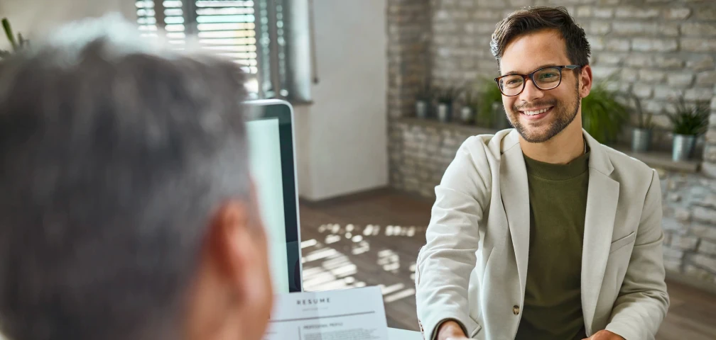 happy-male-candidate-greeting-member-human-resource-team-job-interview-office