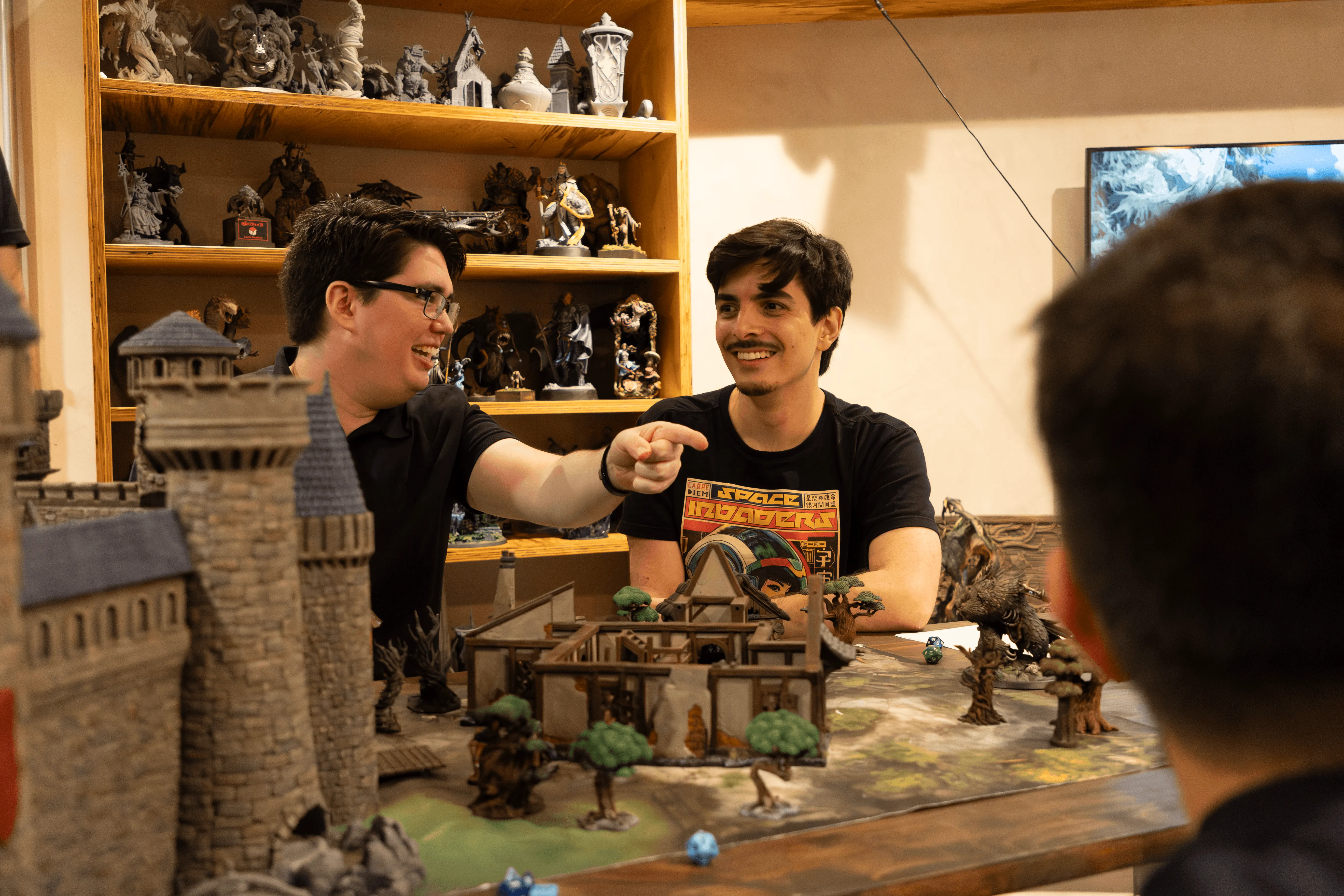 A man using a 3D printer to create a resin miniature from Loot Studios.