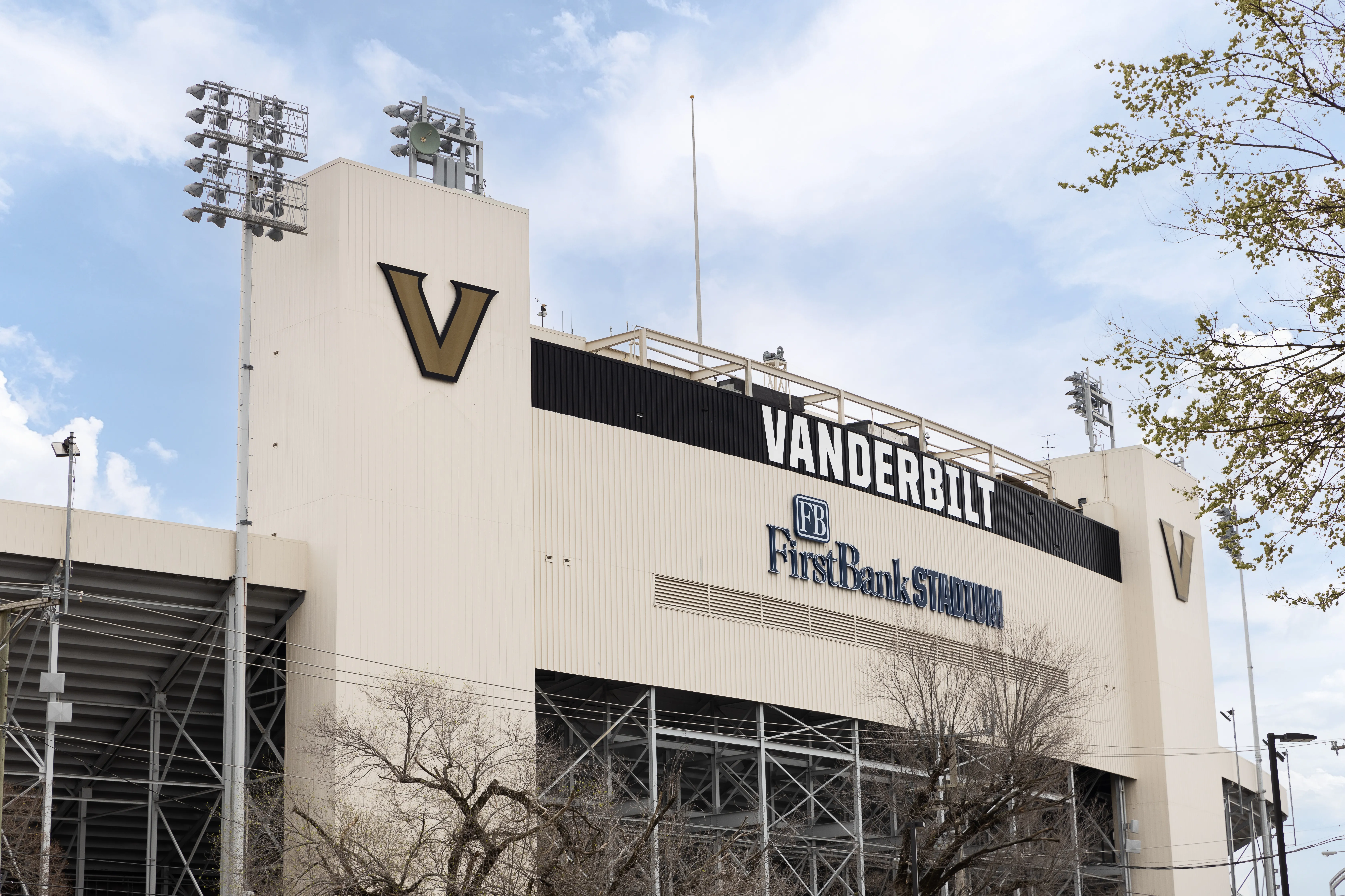 Vanderbilt football stadium, a large venue with seating and field, bustling with fans during a game day atmosphere.