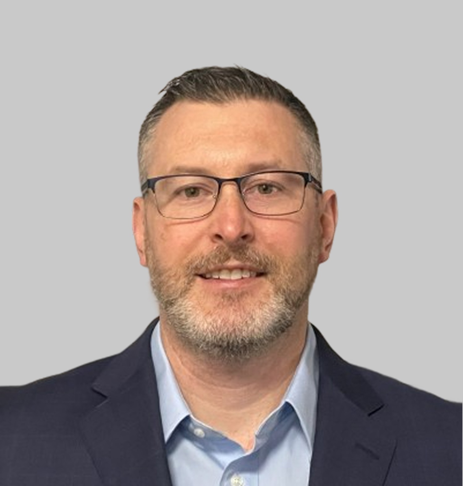 Two people working together on an electronic component, focused on a circuit board with tools visible in the foreground.