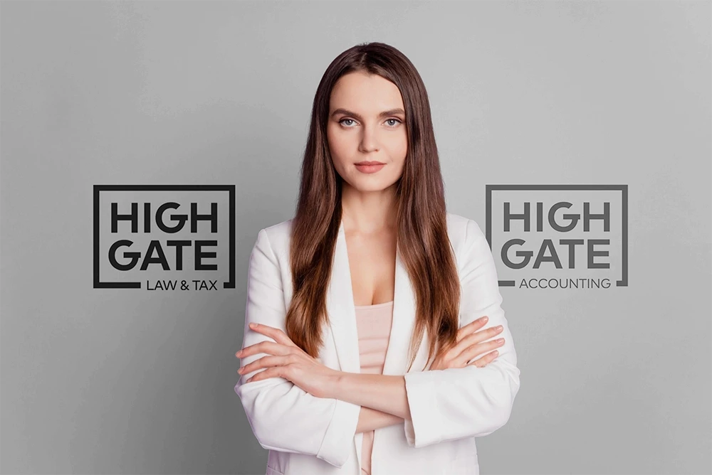Woman standing in front of a wall displaying client company logos