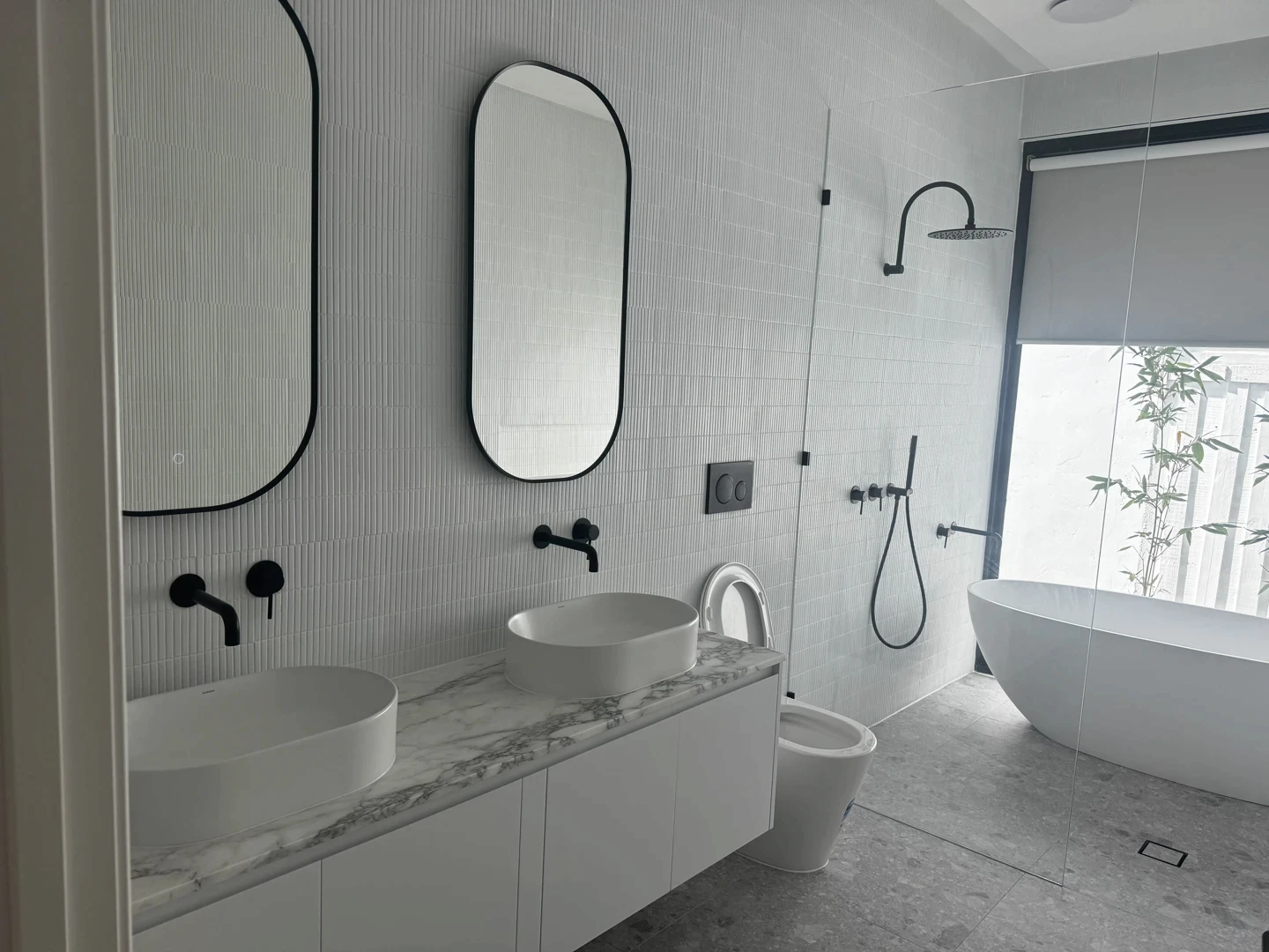 Natural stone bathroom vanity with marble counter surface, basin, mirror detailing, and polished finish.