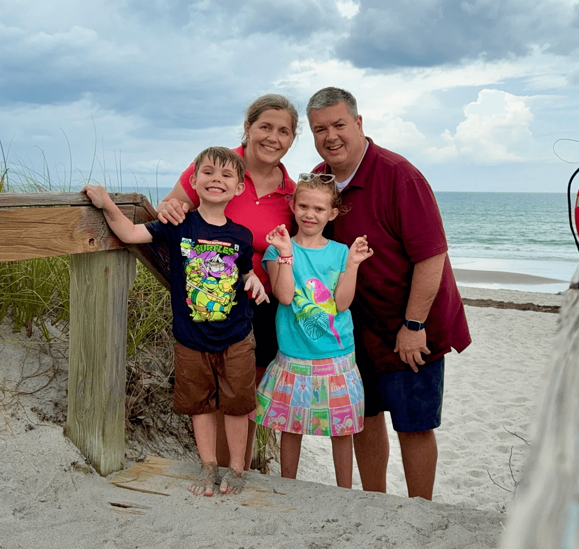 Mike with his wife and children during a family trip to the beach.