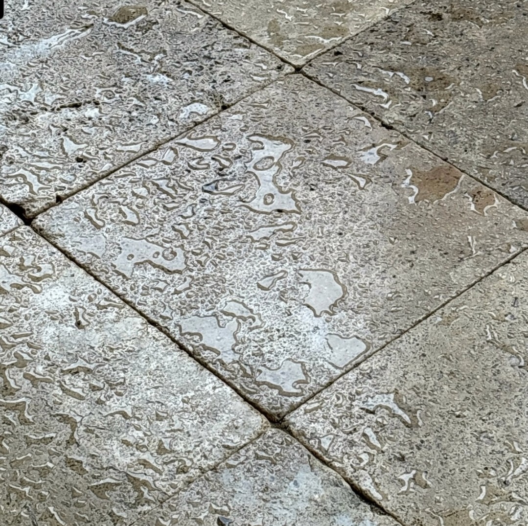 Water beading up on sealed travertine