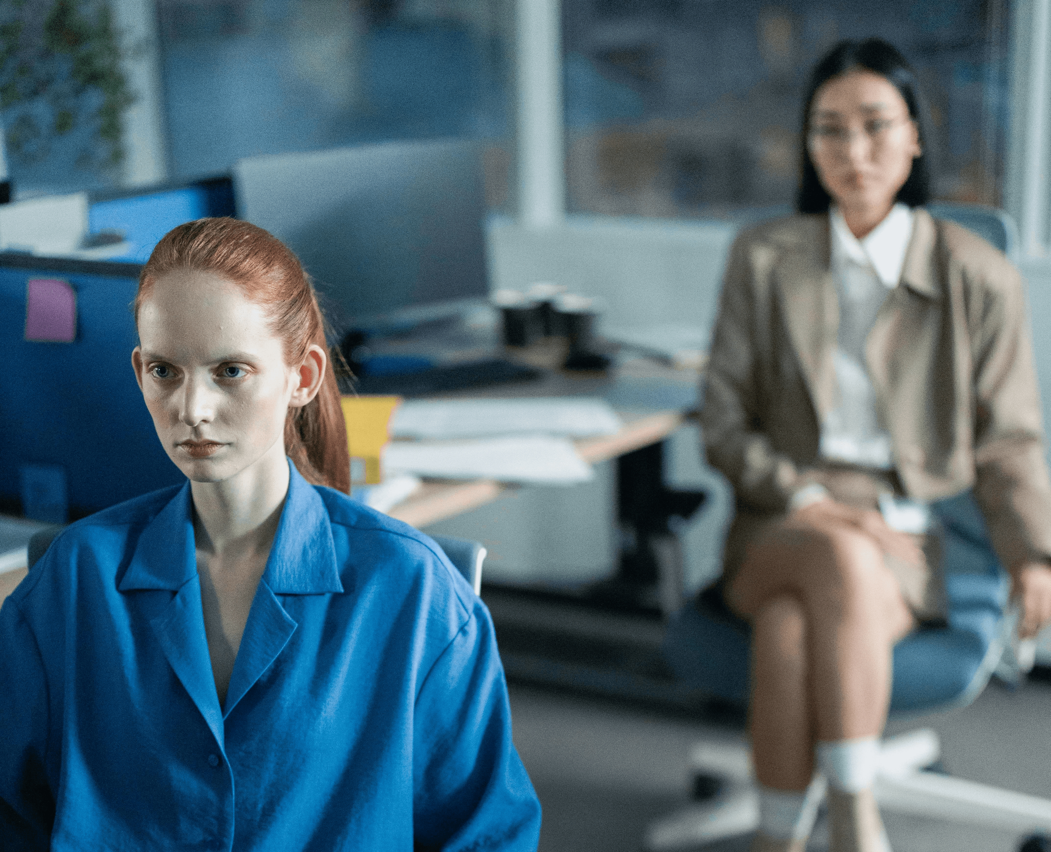Two females looking concerned  in an office