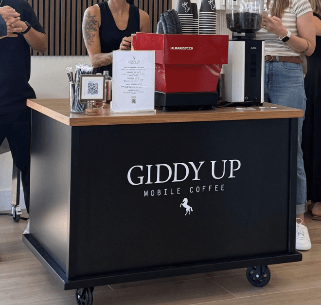 Giddy Up Mobile Coffee barista making a drink at an event