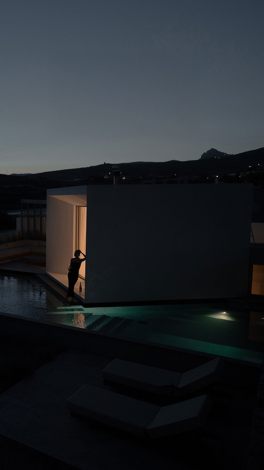 Pool house at night, lit from within