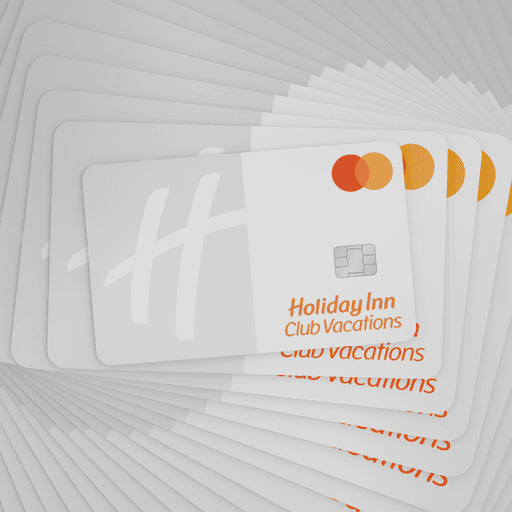 A stack of white credit cards that says “Holiday Inn Club Vacations”.