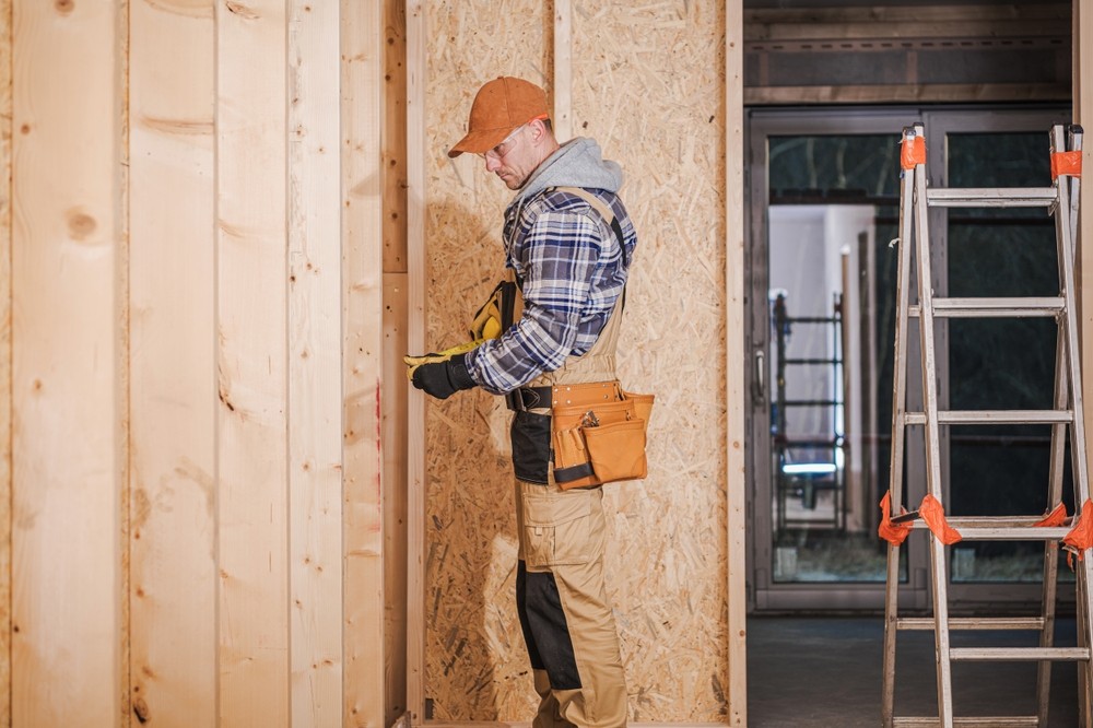 Caucasian General Contractor at Wooden Residential House Construction Site