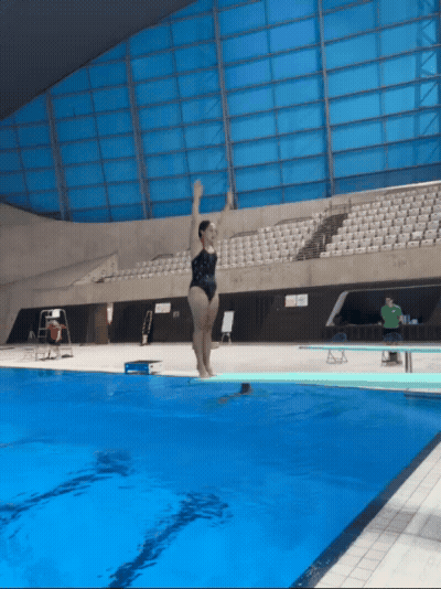 A GIF of Tsui unsuccessfully attempting to do a pike back dive, and faceplanting the water
