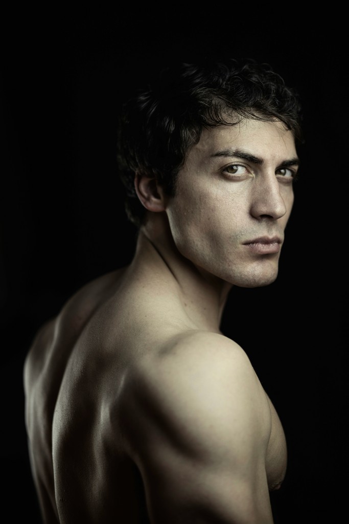 a man with no shirt on posing for a picture