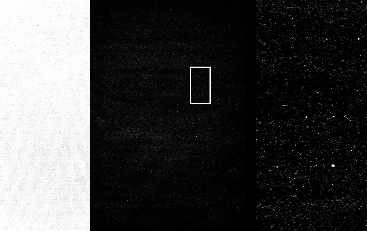 Close-up detail of black paper texture showing scratches dust and worn surface