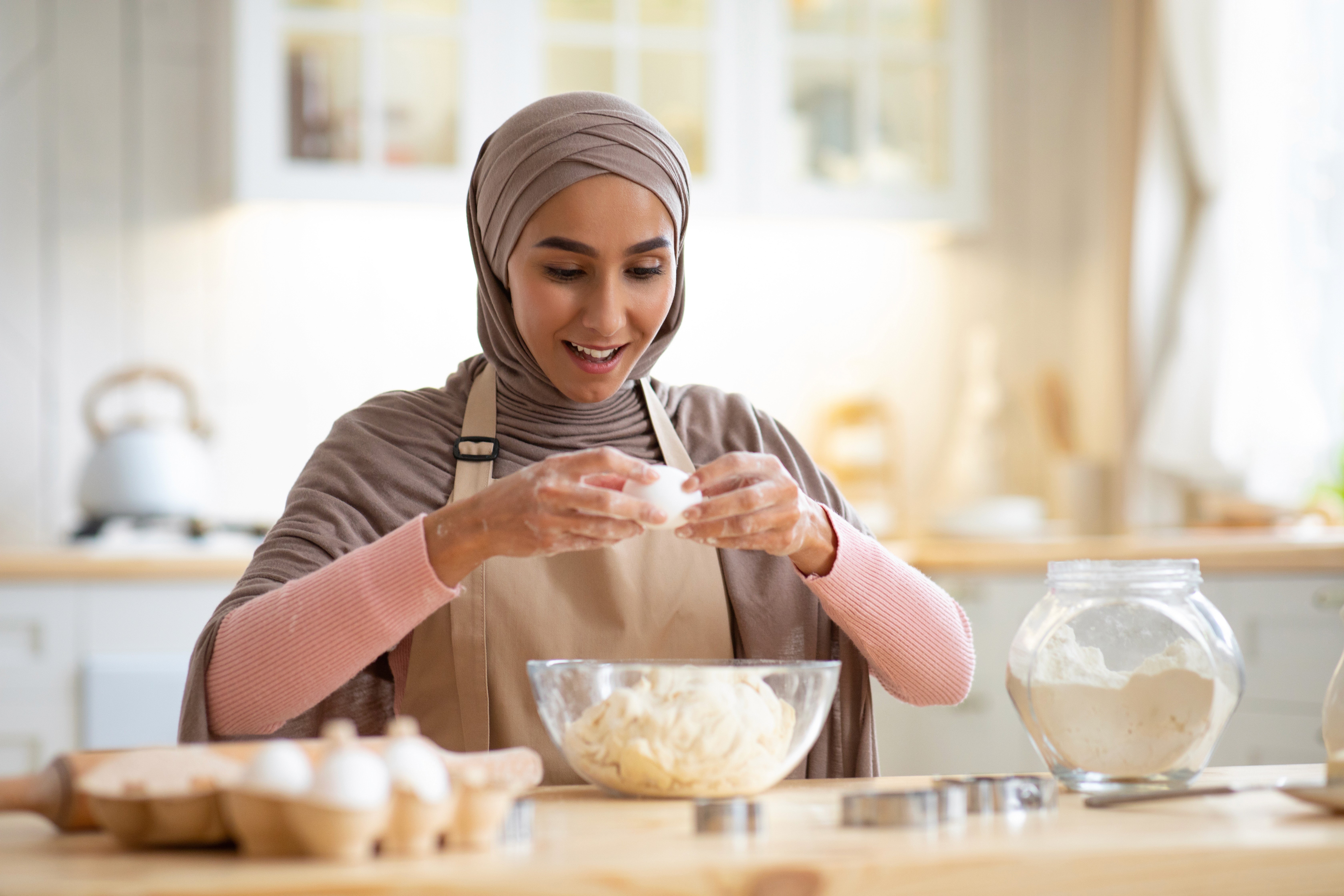 Woman baking in the kitchen using goods secured with Natureland