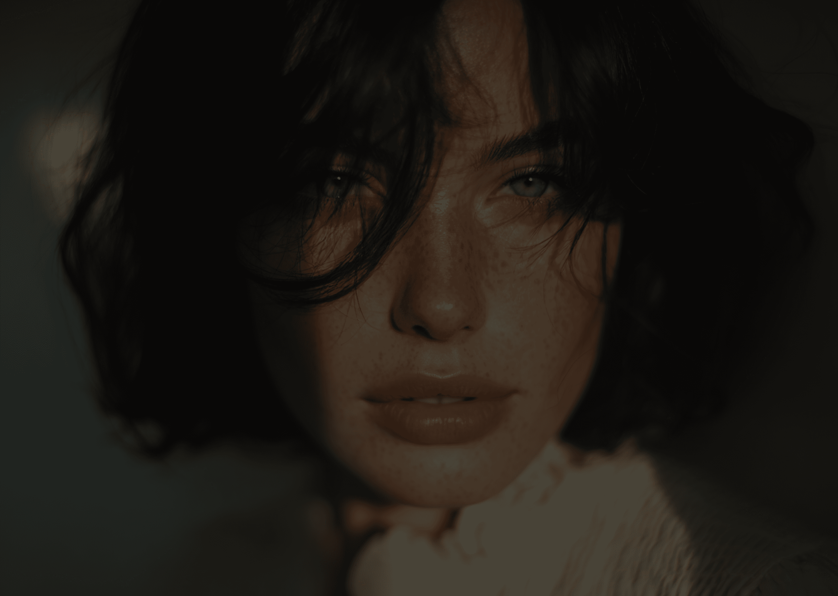 Close-up portrait of a woman with short, dark hair, her eyes looking directly at the camera.