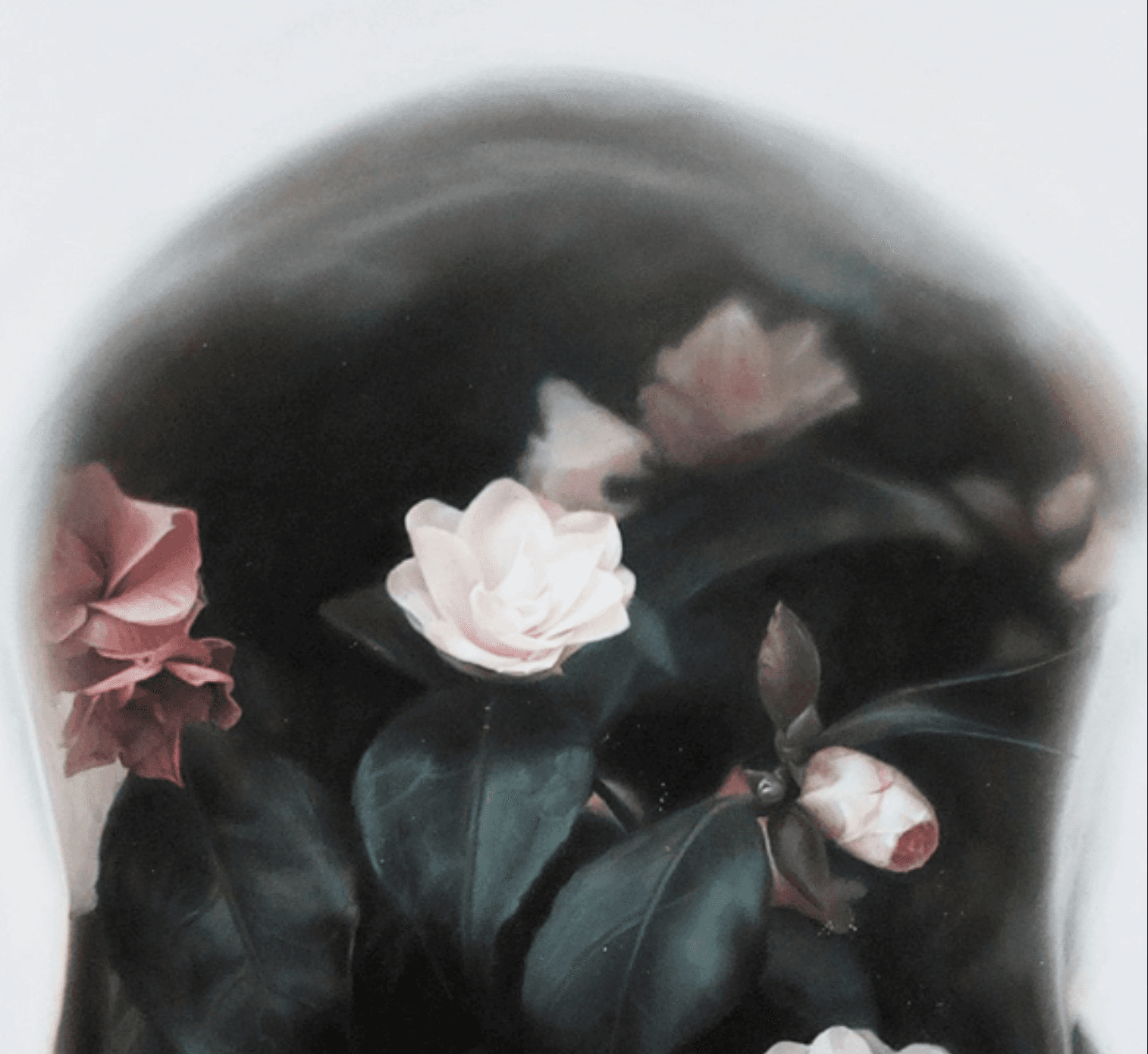 black skull painting overlayed with flowers and roses