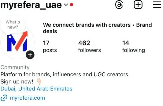 black DSLR camera floating over man's hand at the woods