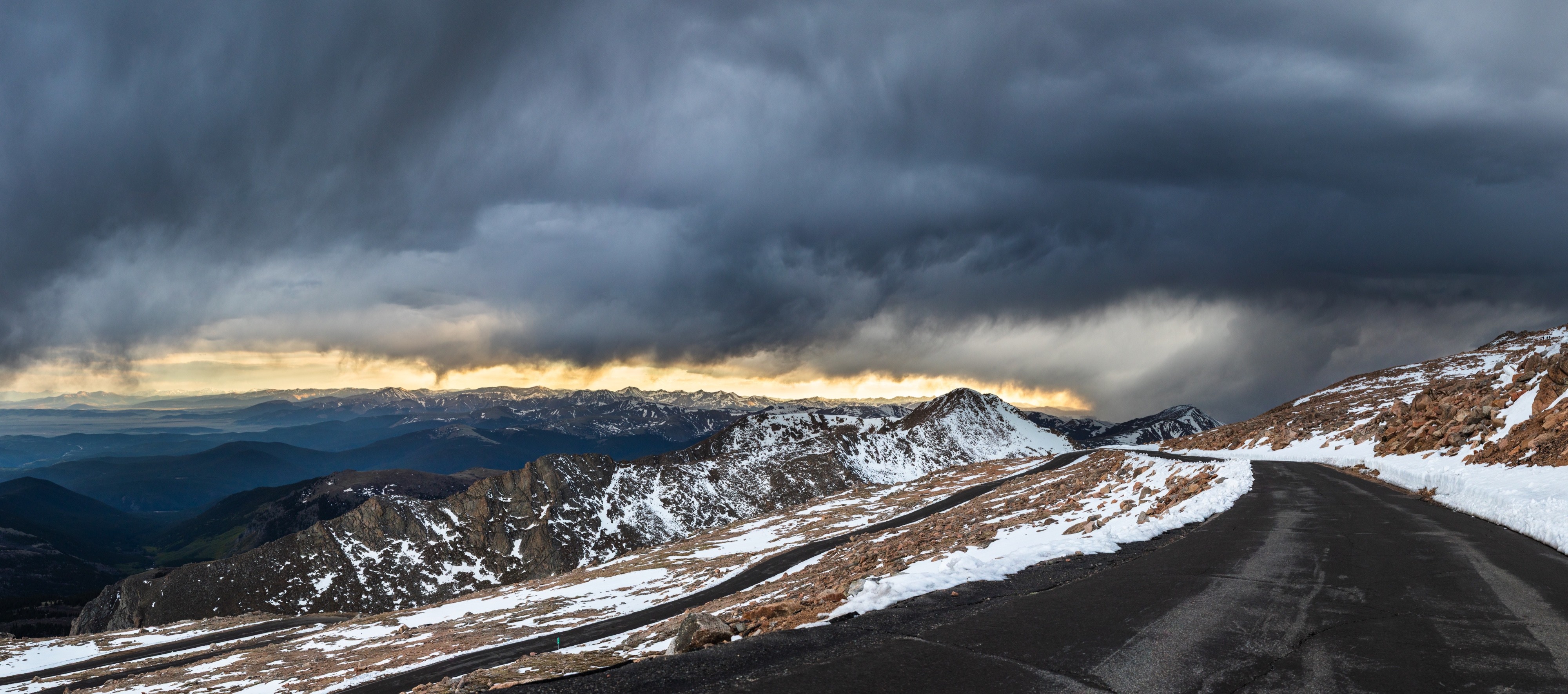 Panoramic landscape photograph of mountains, water, desert, or coast by Lucas Jensen
