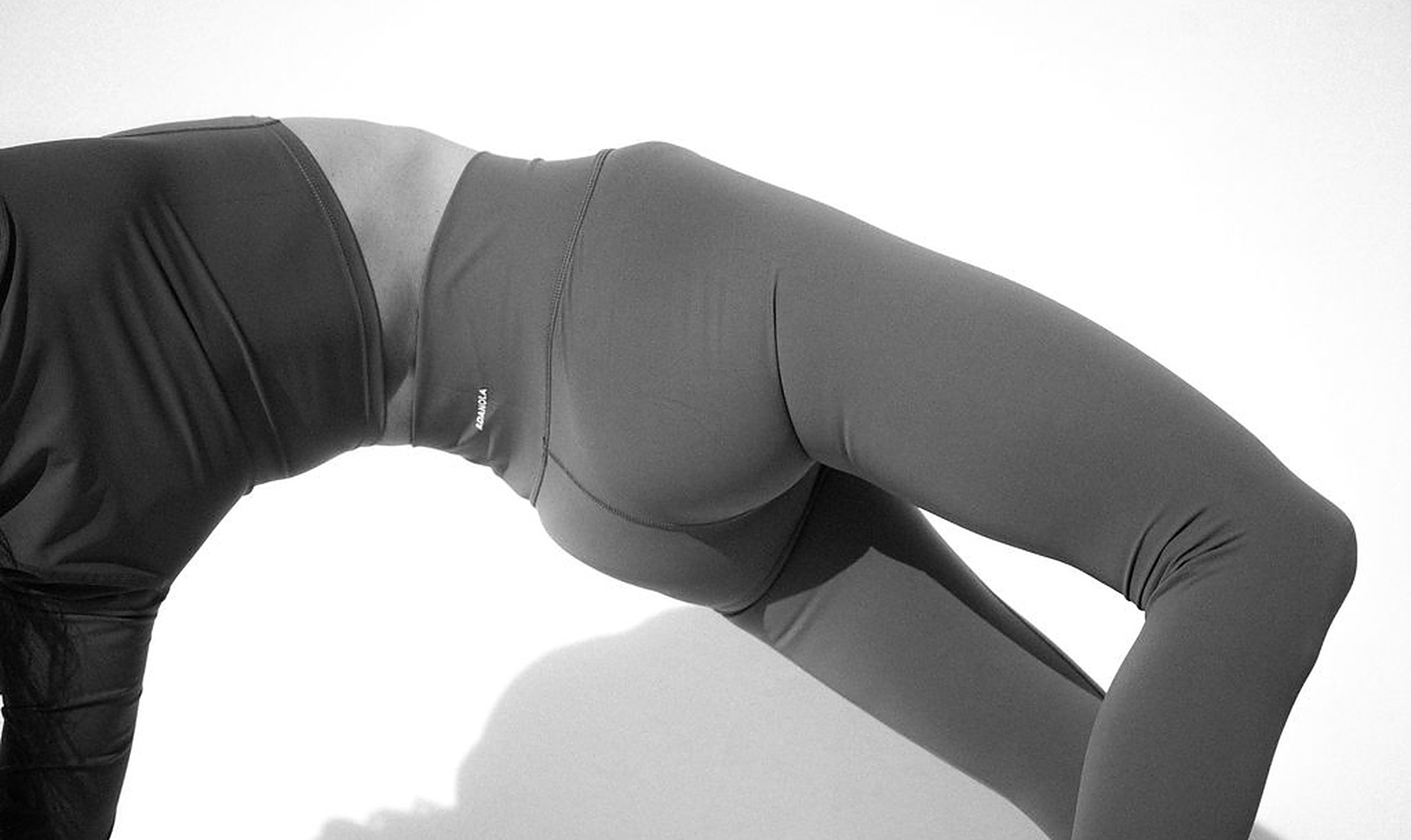 Woman in a bridge pose in soft studio light, movement and body awareness that support libido