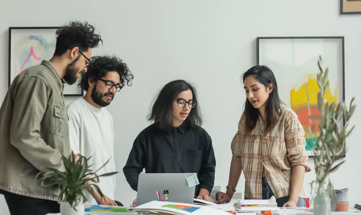 four people around a desk