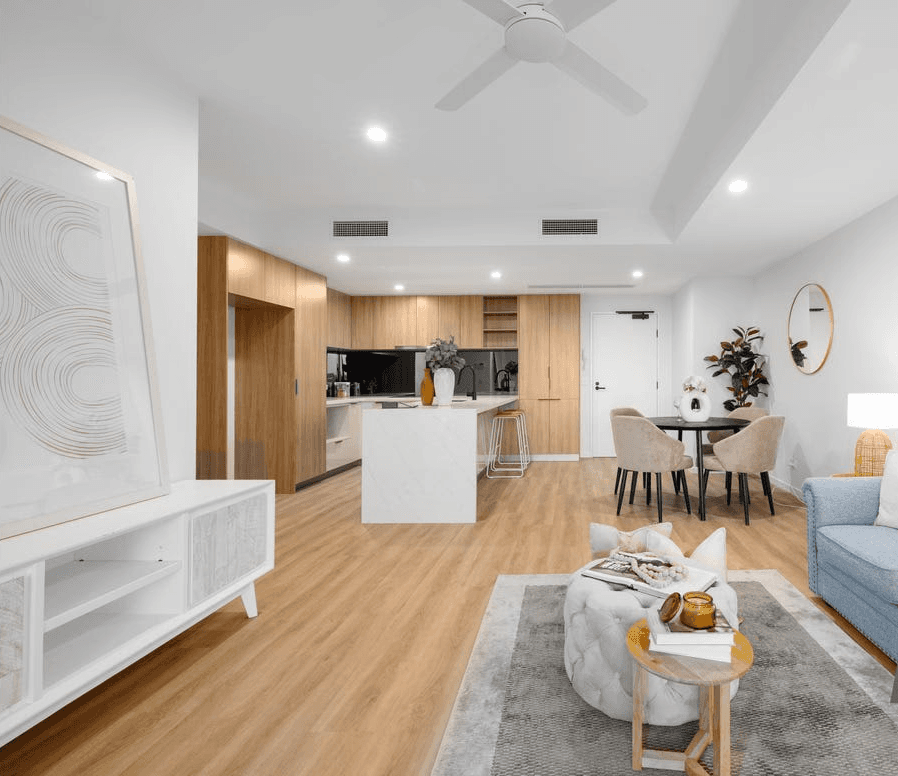 Open-plan Queensland apartment with durable hybrid flooring across kitchen and living areas, built for easy cleaning, water resistance, and everyday comfort.