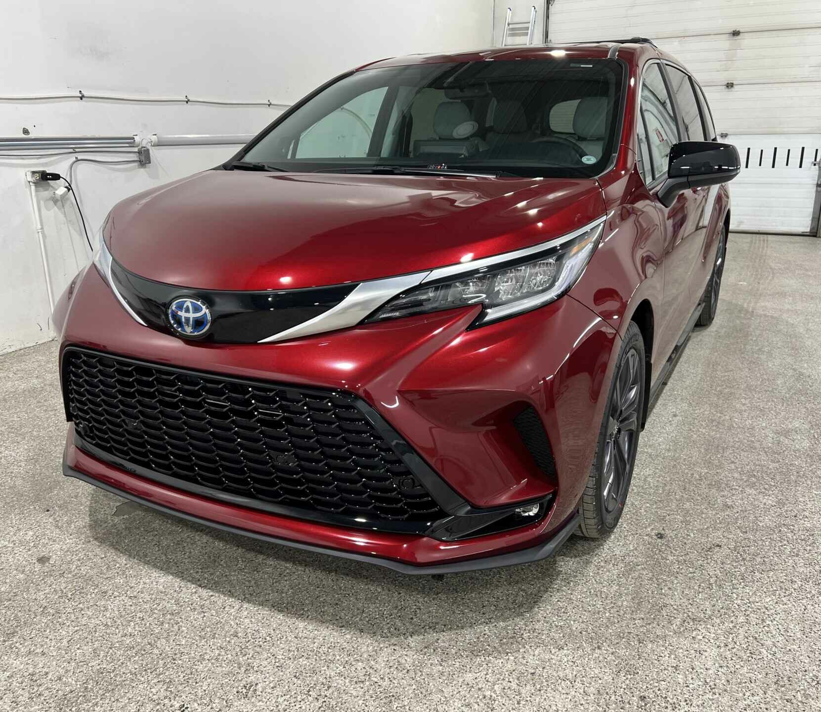 Red Toyota Sienna hybrid minivan