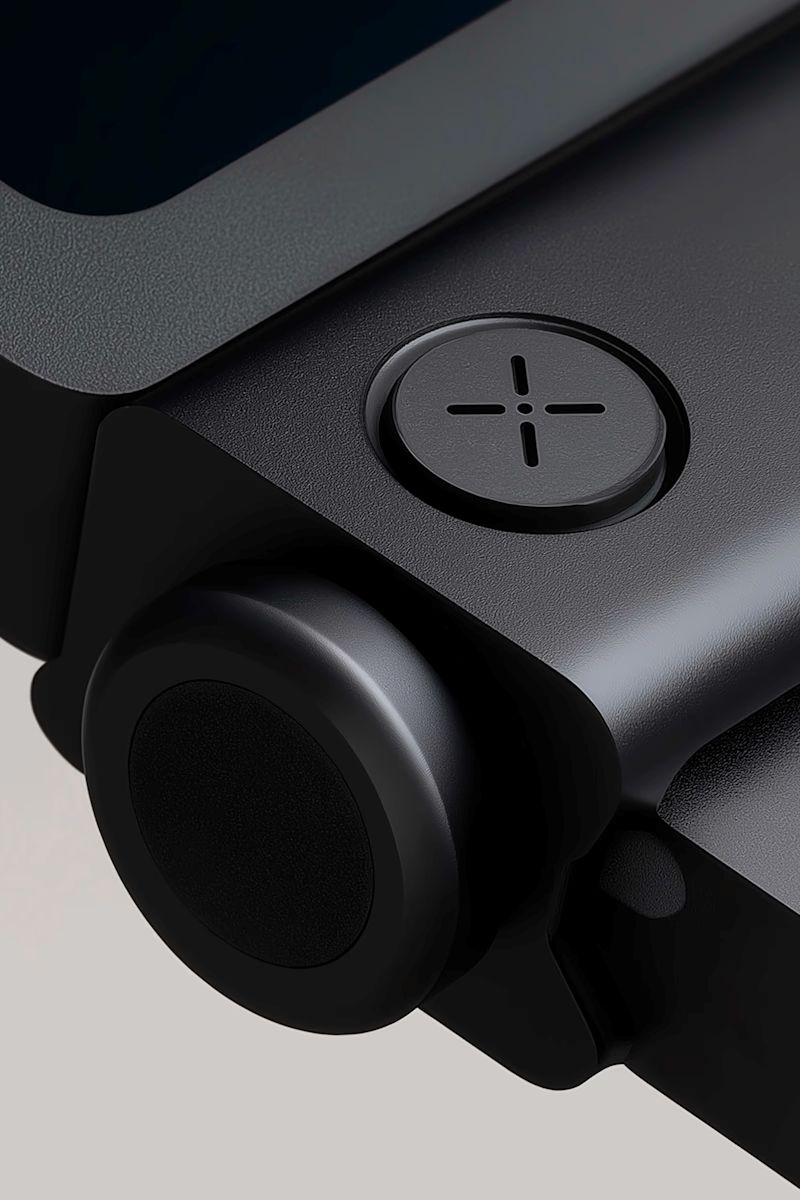 Close-up of a modern black device with a circular button and sleek design, showcasing its minimalistic and industrial aesthetic.