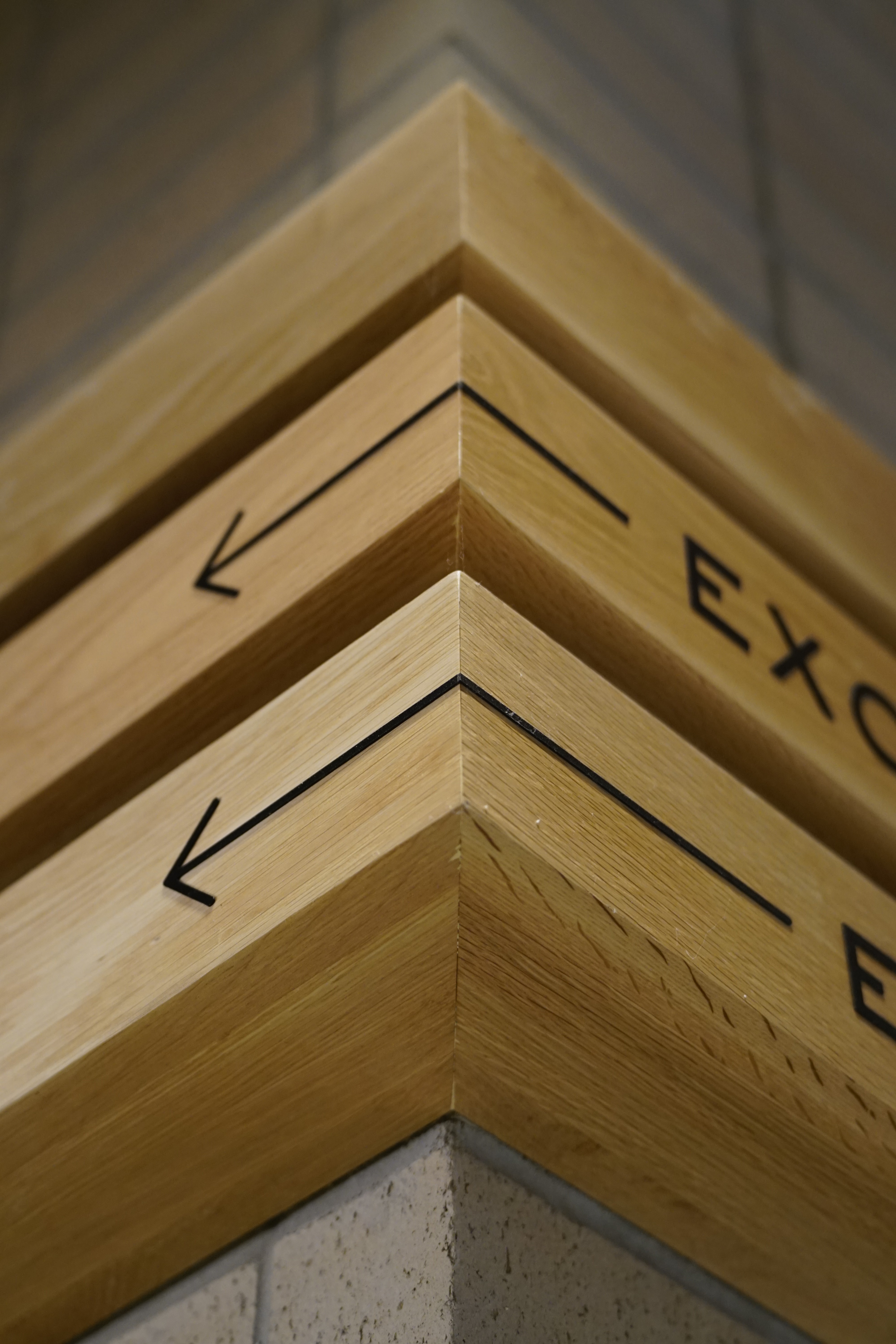 A person stands against a colorful abstract background