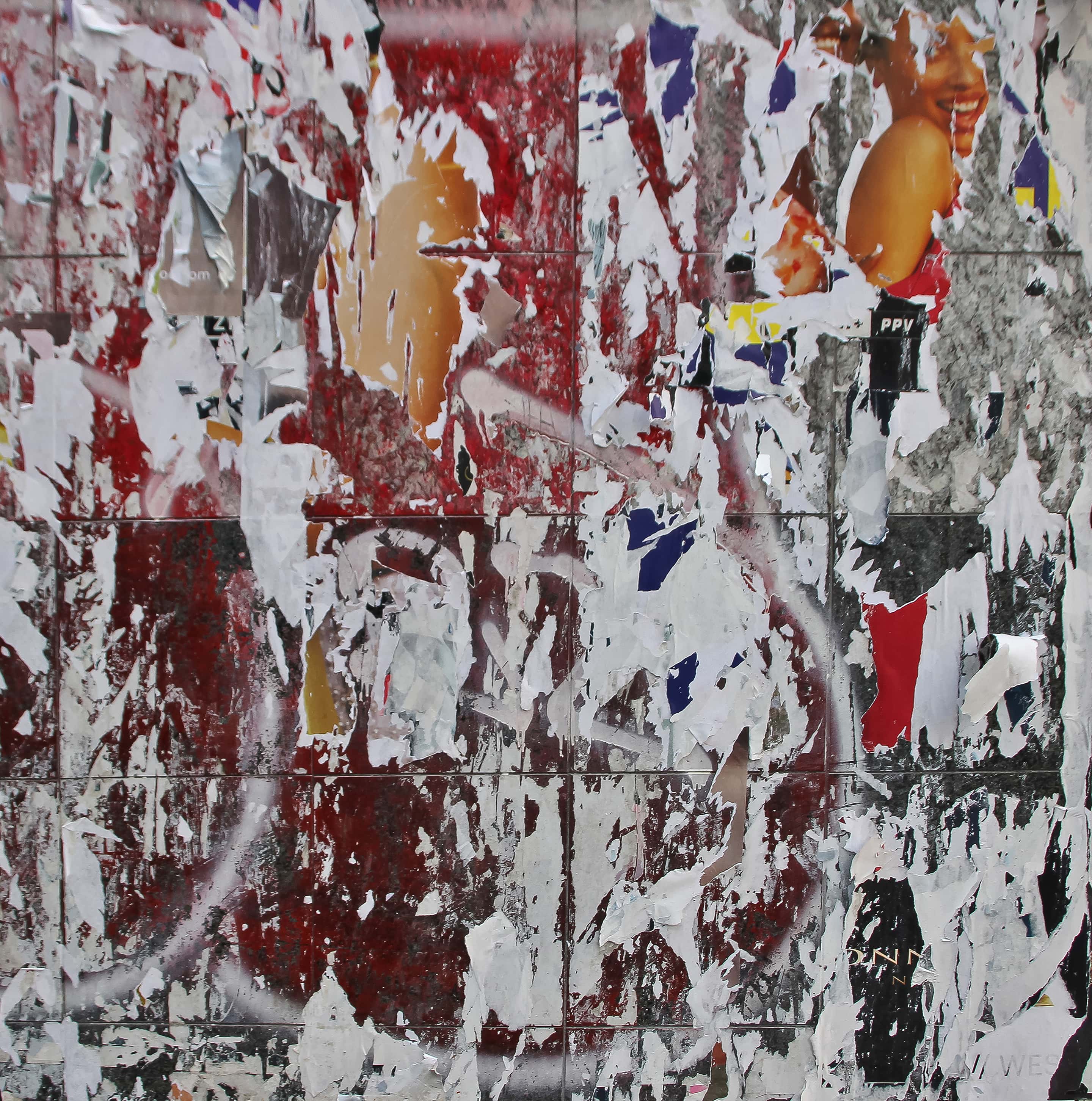 Photograph of a weathered wall layered with red paint, torn posters, and fragments of printed imagery. The scraped surface forms a chaotic yet balanced abstract composition, evoking erosion, memory, and visual noise.