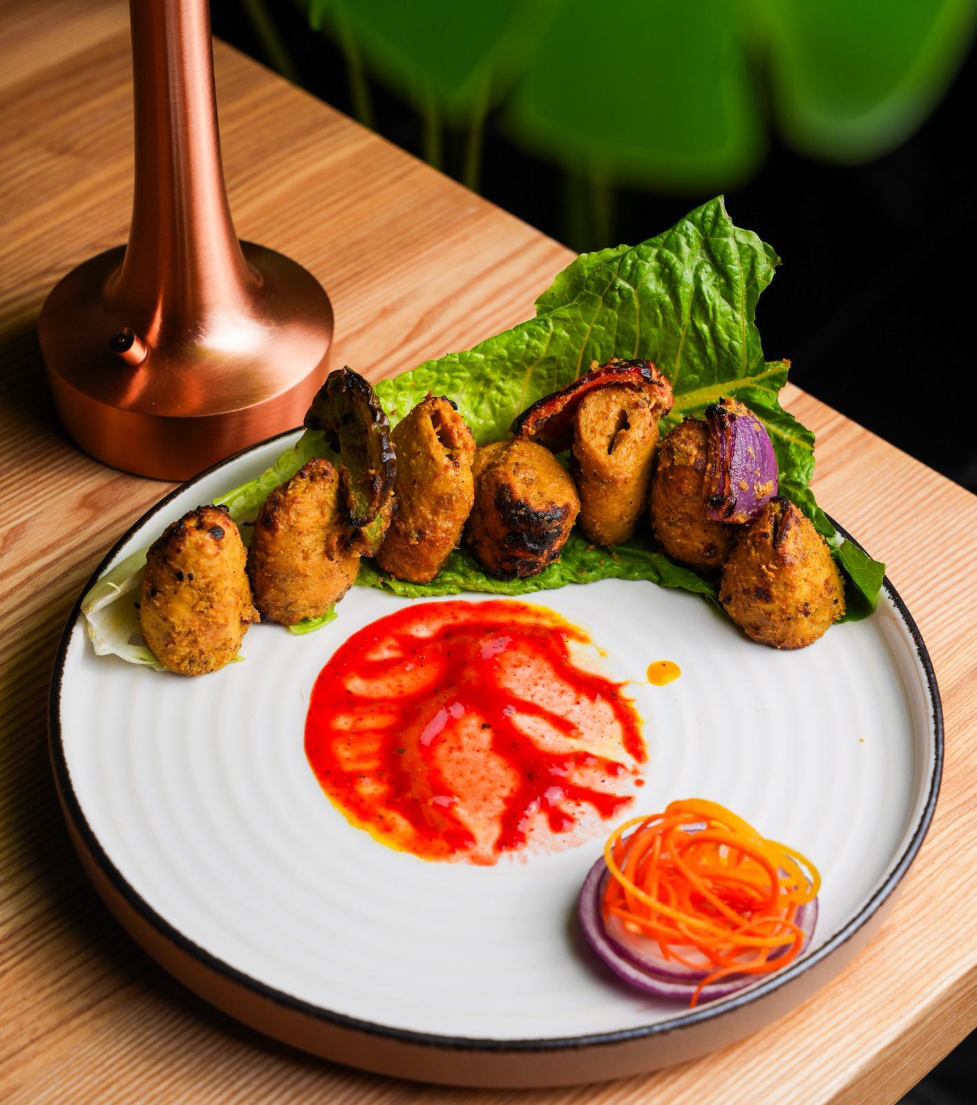 Tandoor-grilled soya chaap served with spices and chutney at Dhoom Greektown Toronto
