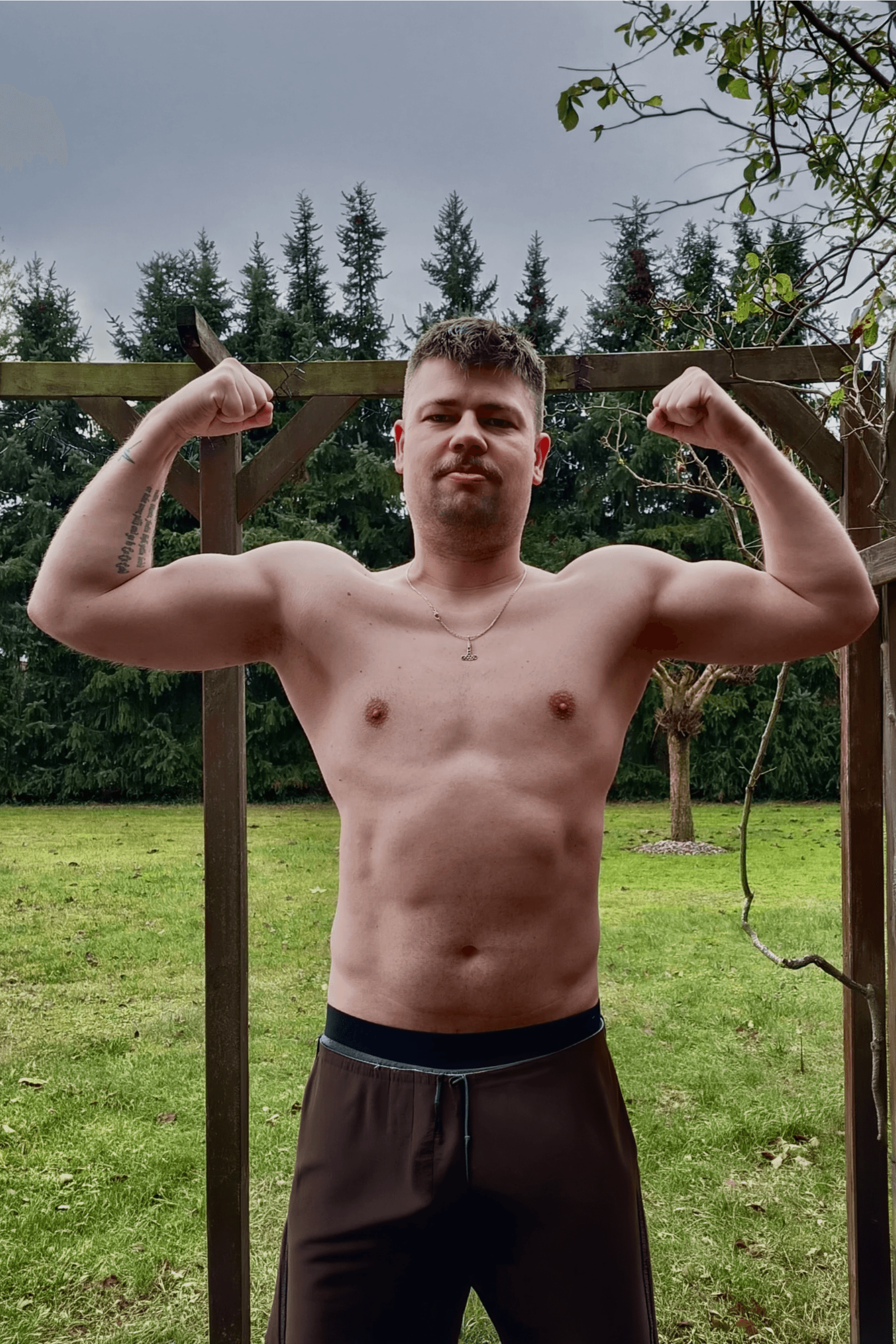 greyscale photo of woman in bralette inside room
