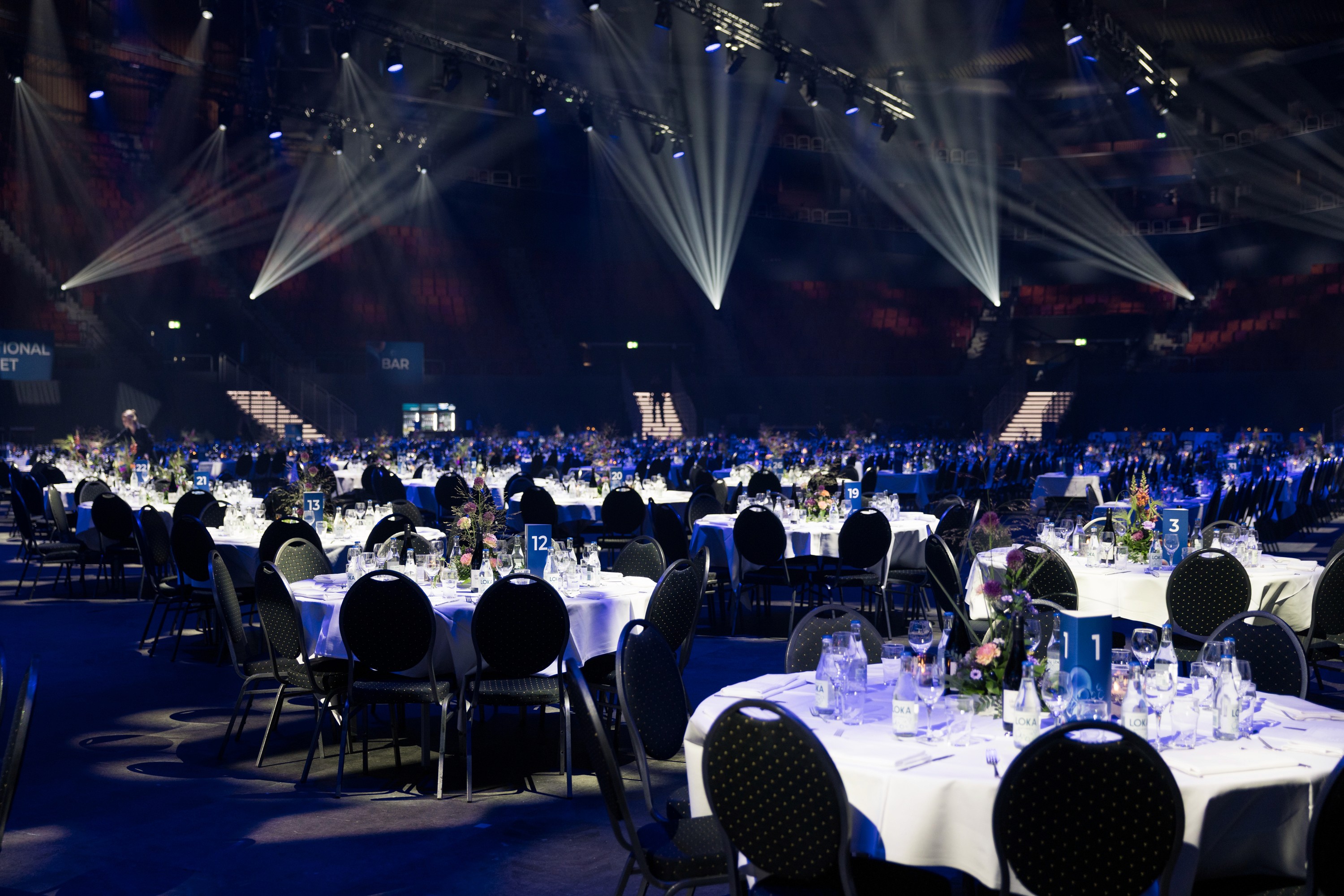 stolar och bord i ett stort rum för evenemang under stroboskopbelysning