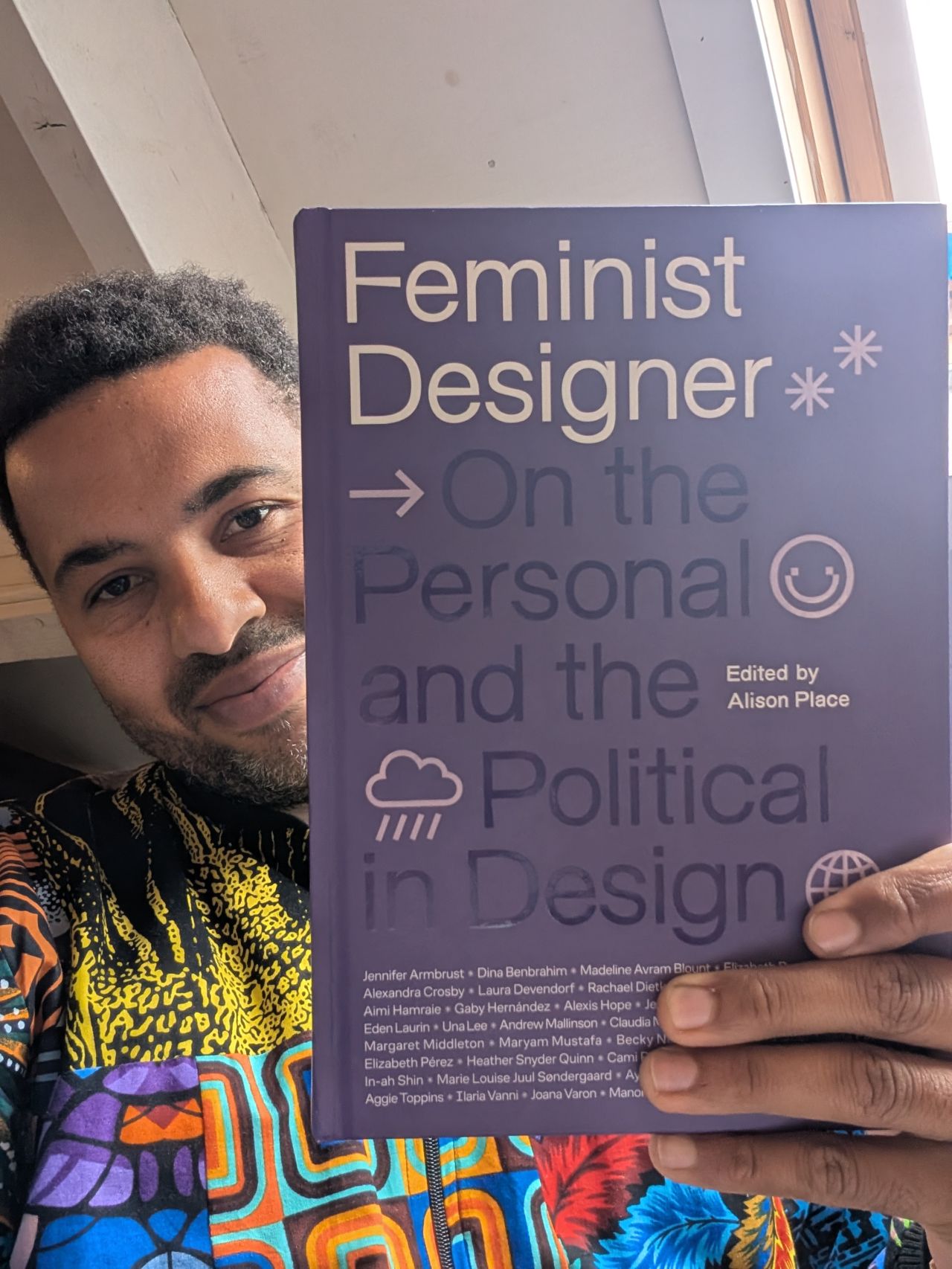 Black Man holding a book about Feminism Designer