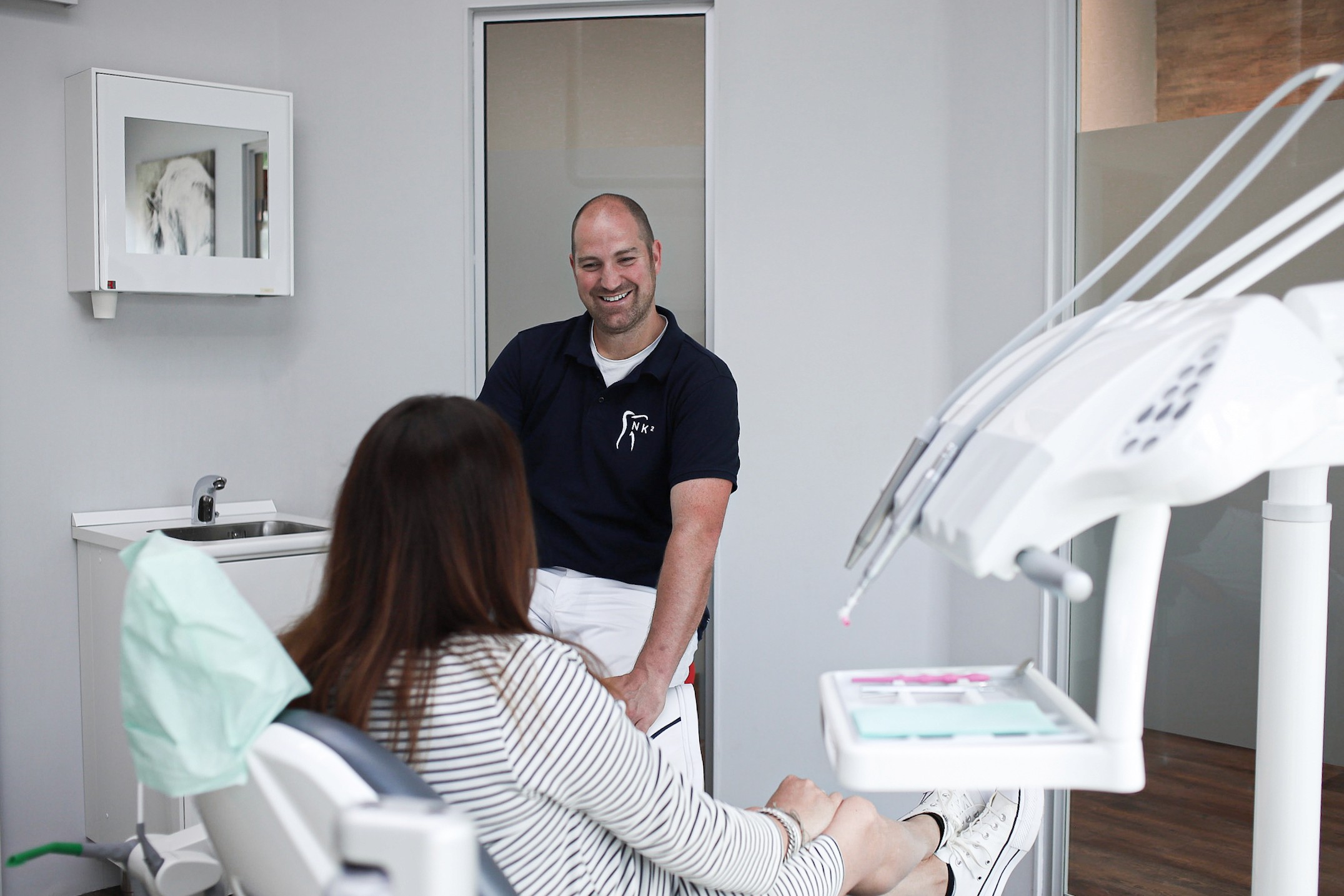 An orange cube-shaped side table is shown.