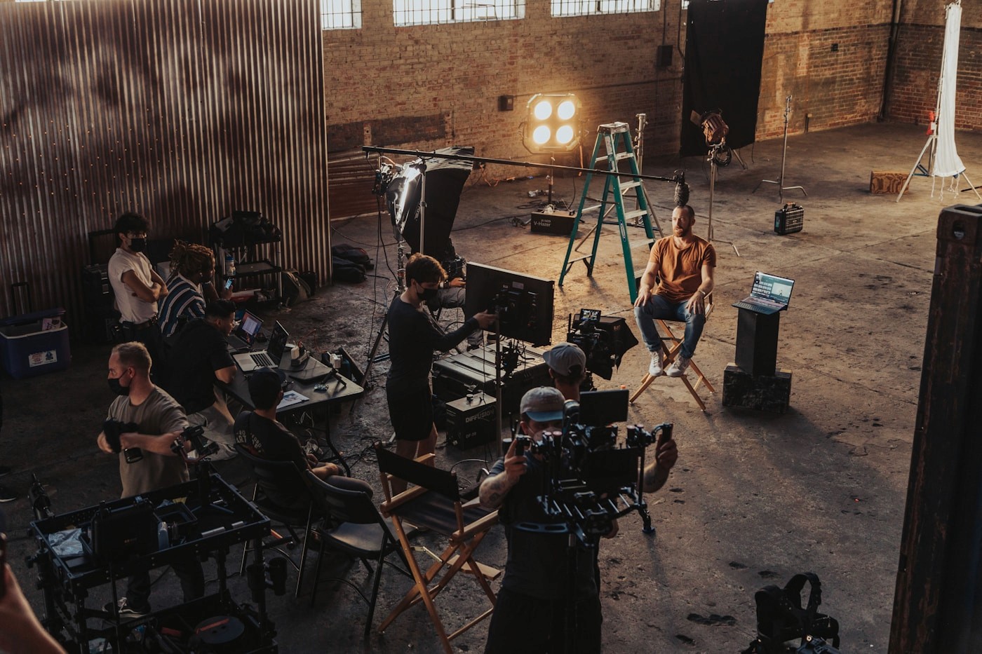 Production team gathered around a camera during a commercial shoot review