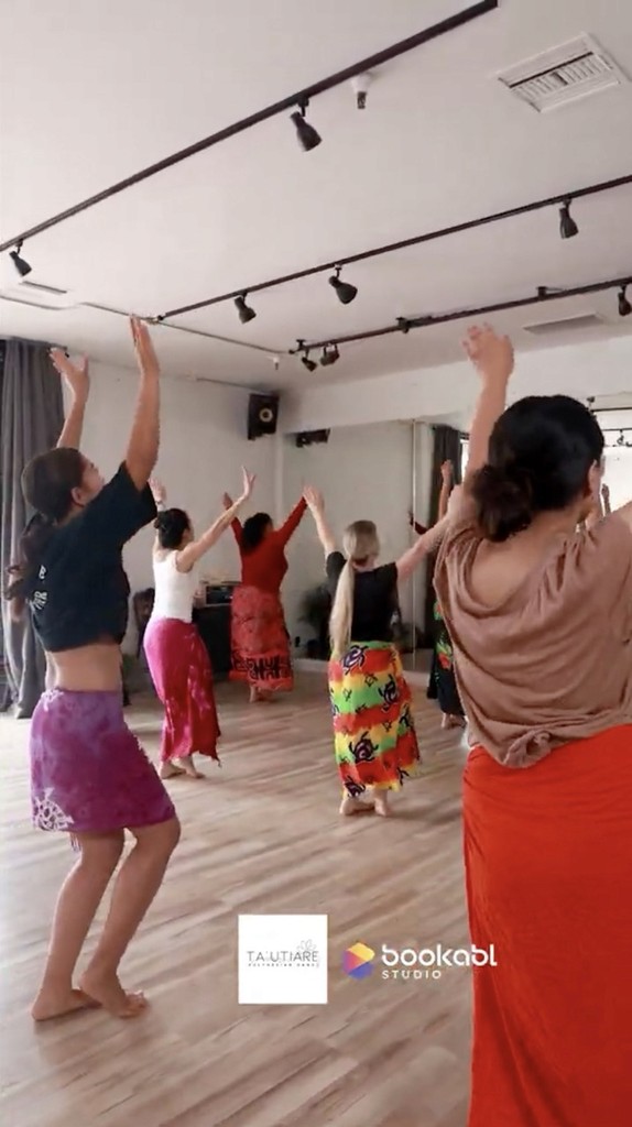 Tautiare polynesian dance team with hand up at bookabl studio in oceanside