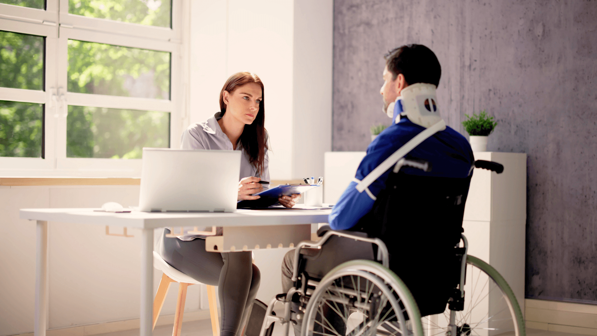 injury attorney meeting with wheelchair-bound catastrophic injury victim