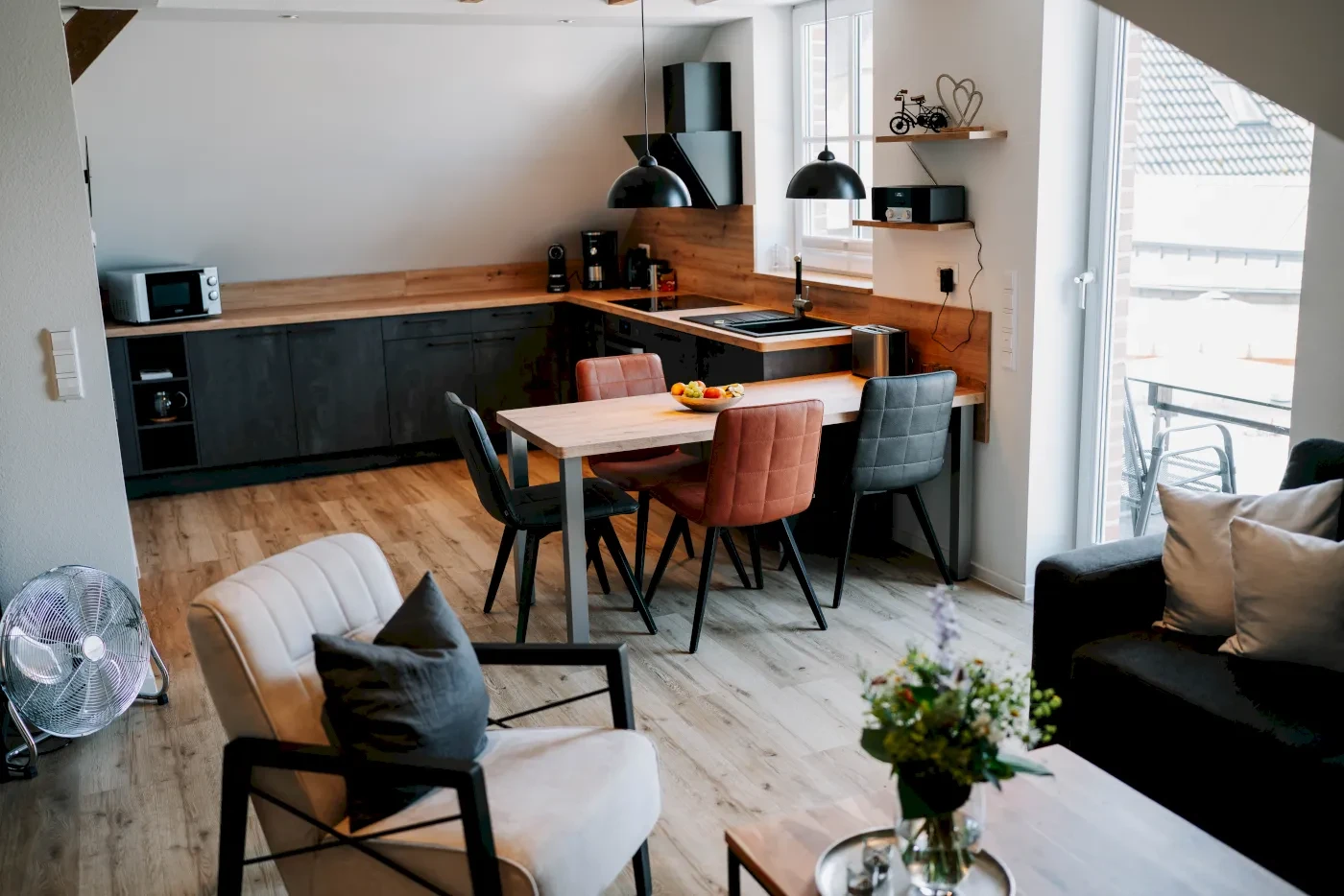 Ferienwohnung mit Blick auf den Essstisch und die Küche aus Richtung des Sofas.