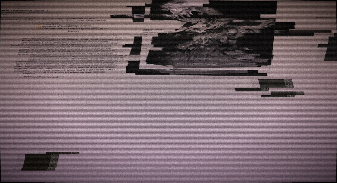 Glitchy digital screen with abstract patterns and text elements.